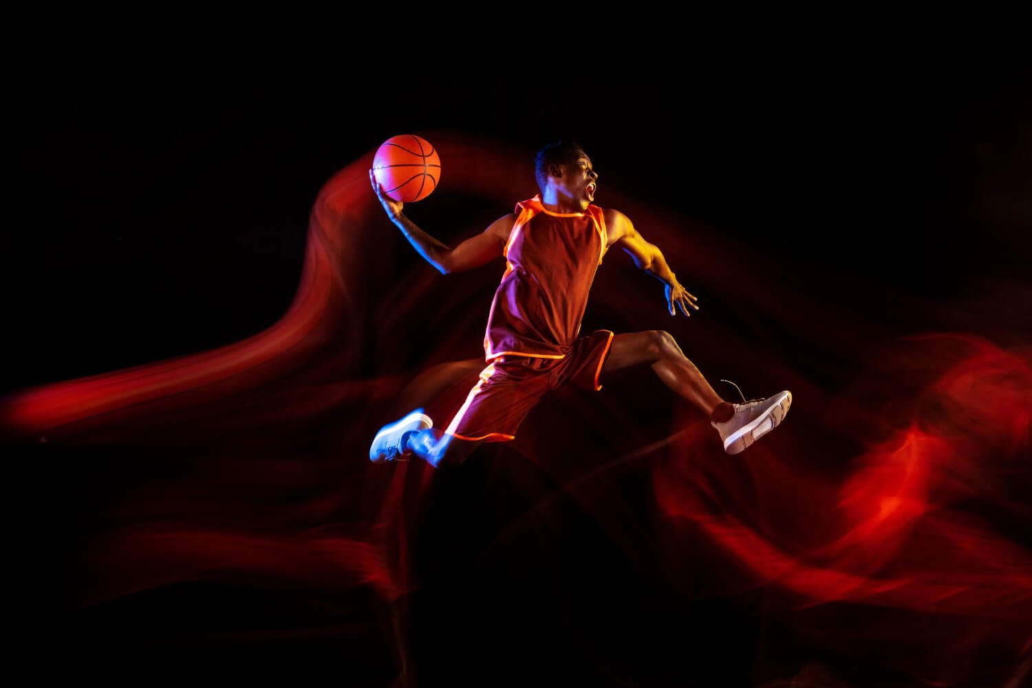 emotions-winner-african-american-young-basketball-player-red-team-action-neon-lights-dark-studio-background-concept-sport-movement-energy-dynamic-healthy-lifestyle