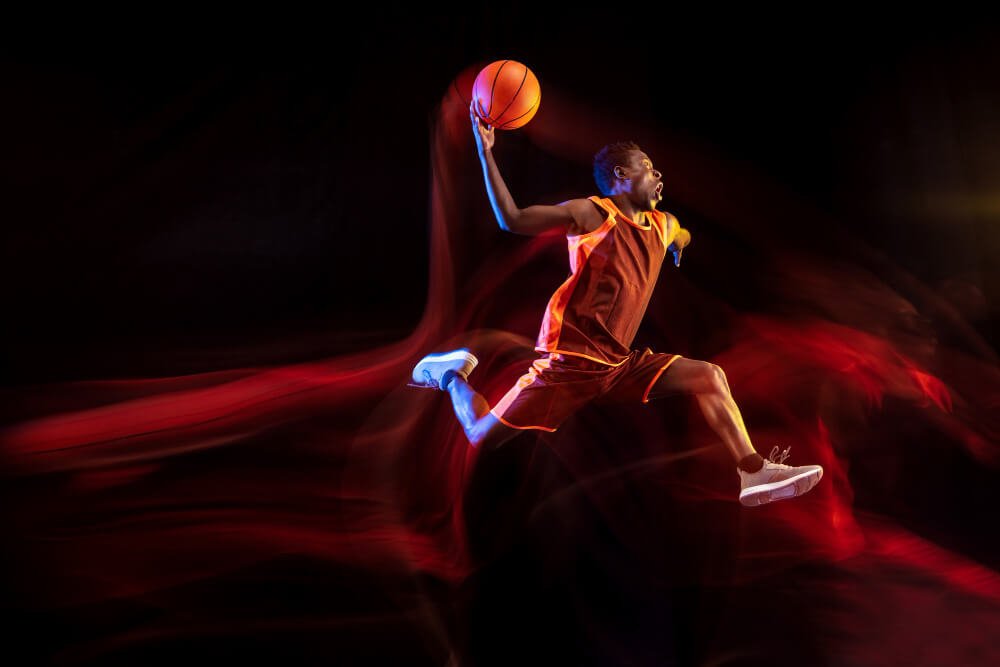 one-jump-before-winning-african-american-young-basketball-player-red-team-action-neon-lights-dark-studio-background-concept-sport-movement-energy-dynamic-healthy-lifestyle